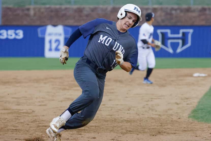 Flower Mound High’s Sam Distel completes a run during the third inning of a baseball game...