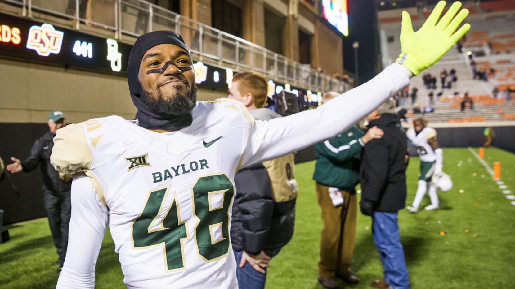 Baylor's Travon Blanchard waves to fans as he leaves the field after a victory over Oklahoma...
