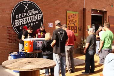 Guests line up to sample offerings at the one-year anniversary of the Deep Ellum Brewing Co....