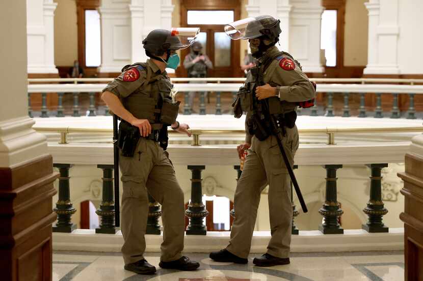 State police officers guard the state capitol following the House opening ceremony for the...