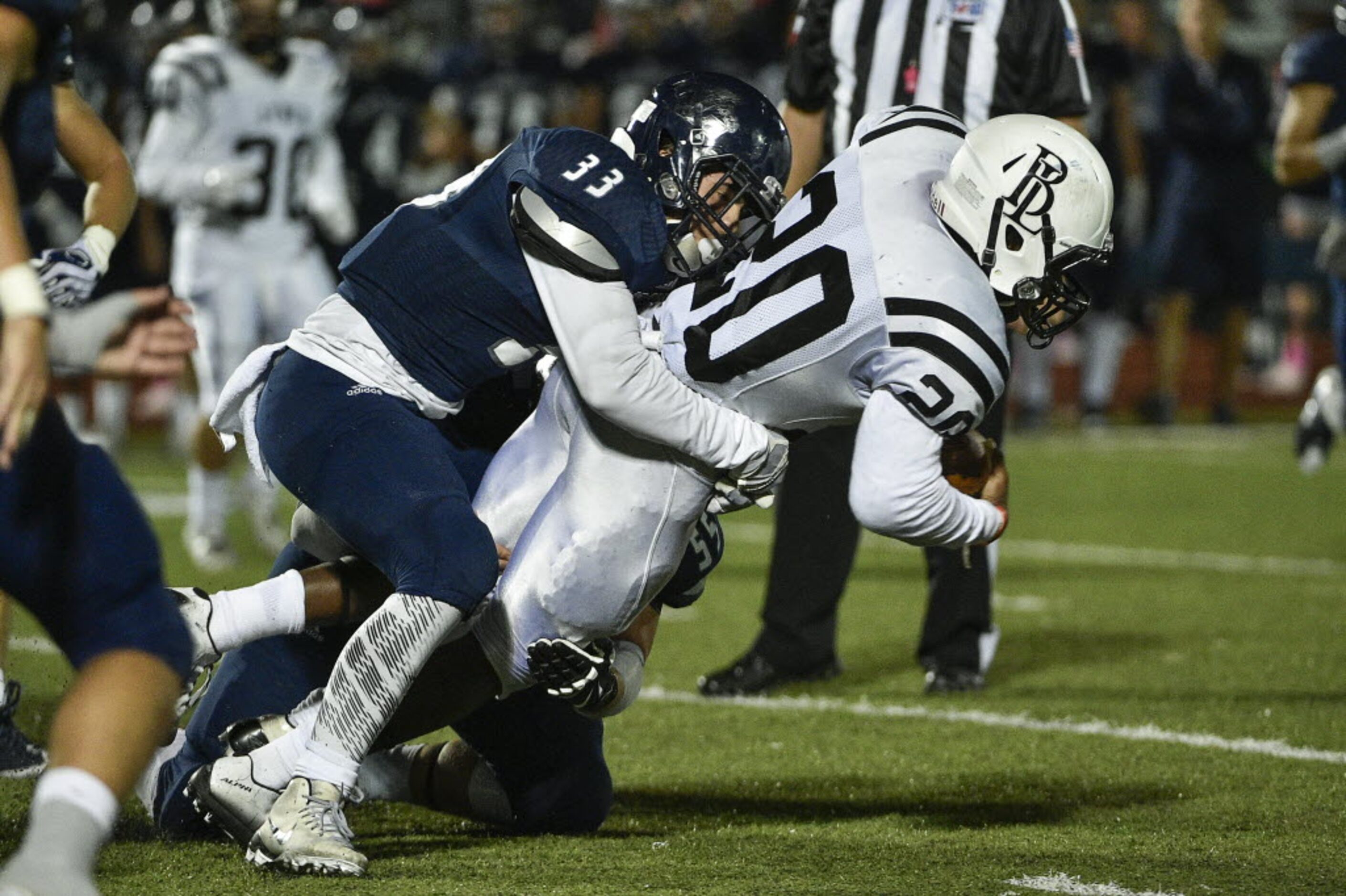 Liberty linebacker Caleb Bridges (33) tackles Bishop Lynch running back Jermaine Mask (20)...