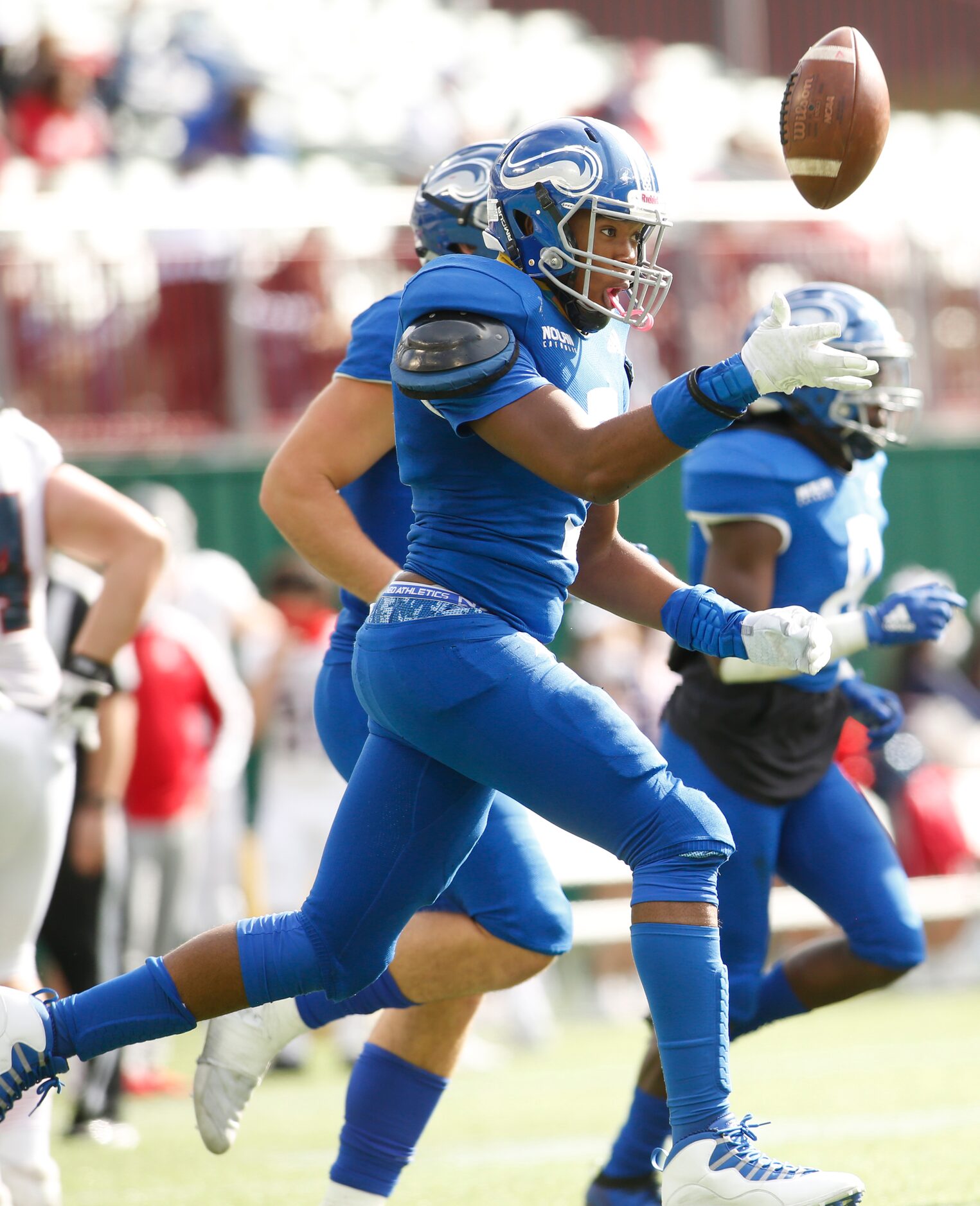 Fort Worth Nolan defensive end Curlee Thomas (9) enthusiastically bolts to the team bench...