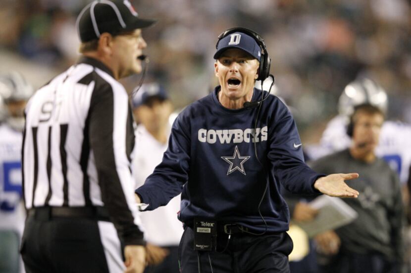 Dallas Cowboys head coach Jason Garrett questions a call from head linesman Jerry Bergman...