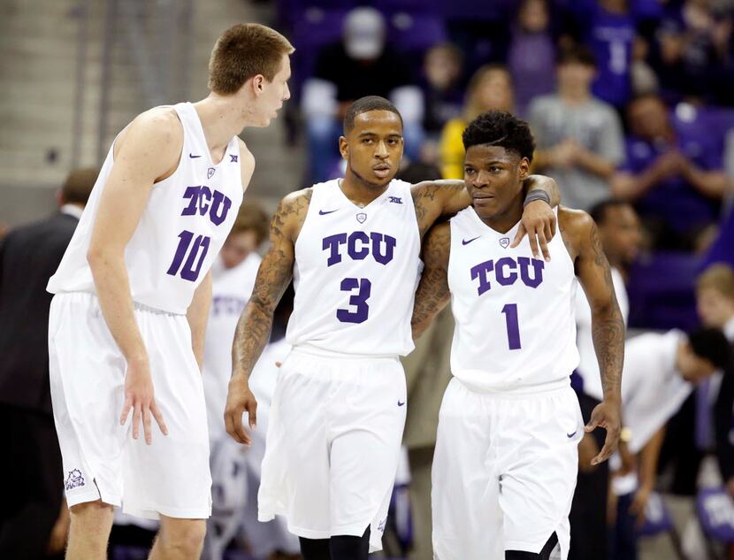TCU guard Malique Trent (3) walks upcourt with teammates guard Chauncey Collins, right, and...