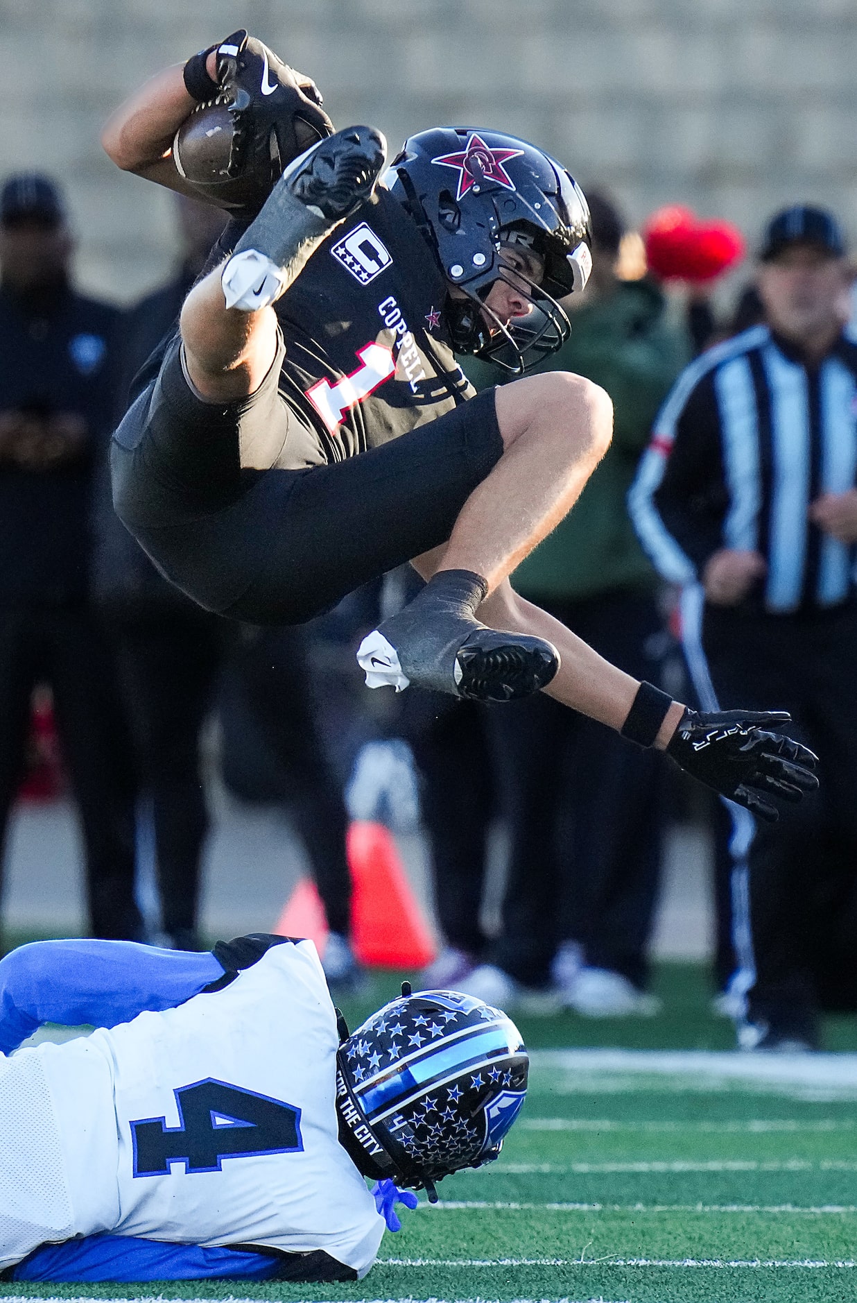 Coppell wide receiver Tucker Cusano (1) is knocked off his feet by North Crowley’s Draden...