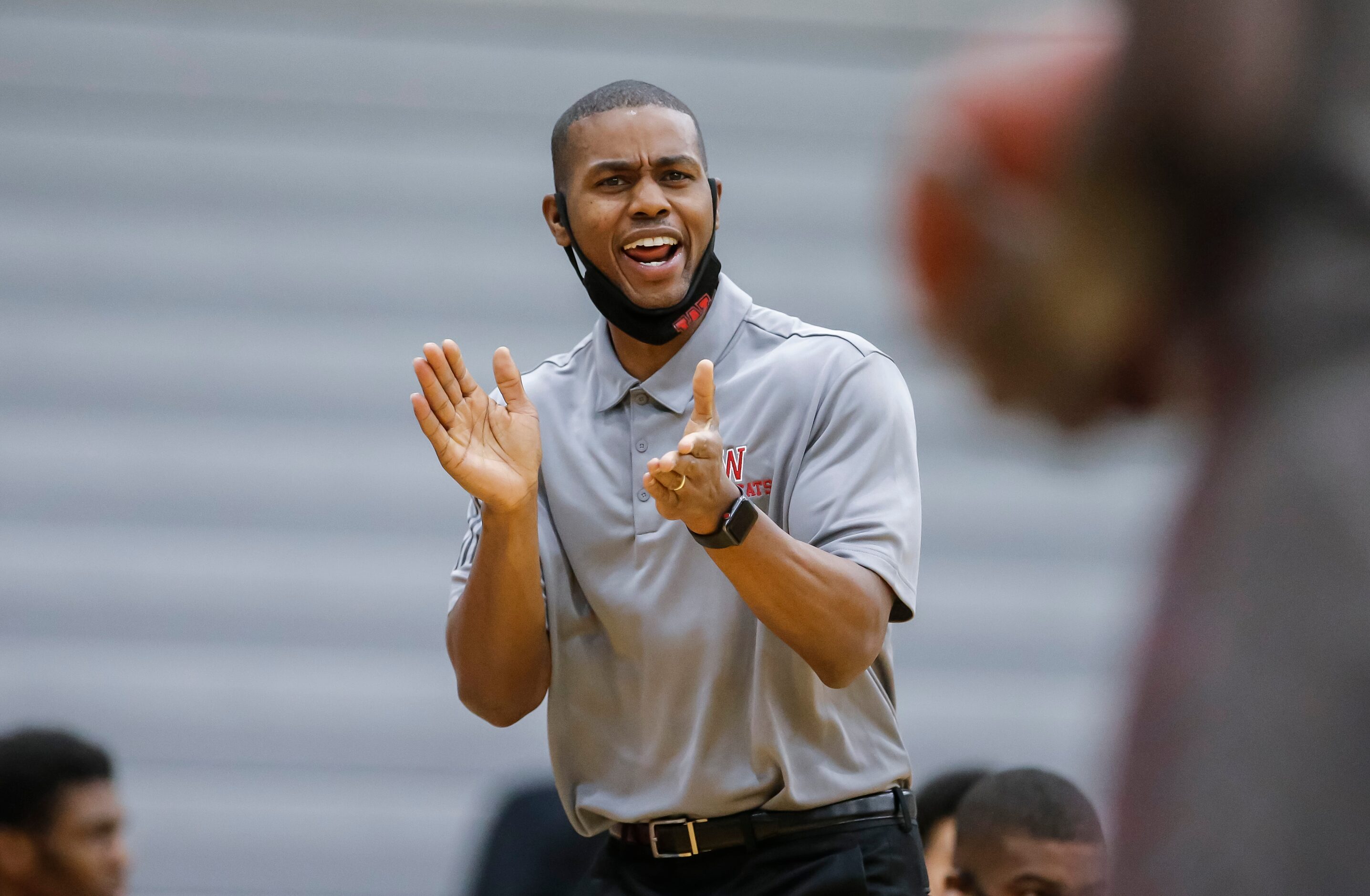 Woodrow Wilson coach Corey Johnson rallies his team during a high school basketball game...