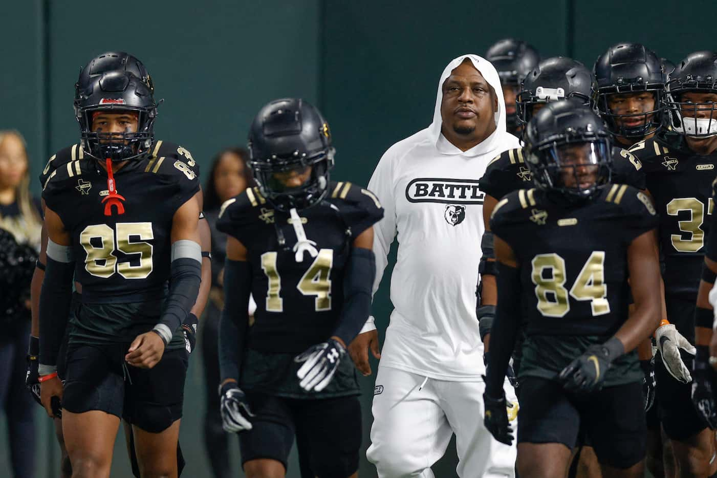 South Oak Cliff head coach Jason Todd walks with his team onto the field before the first...