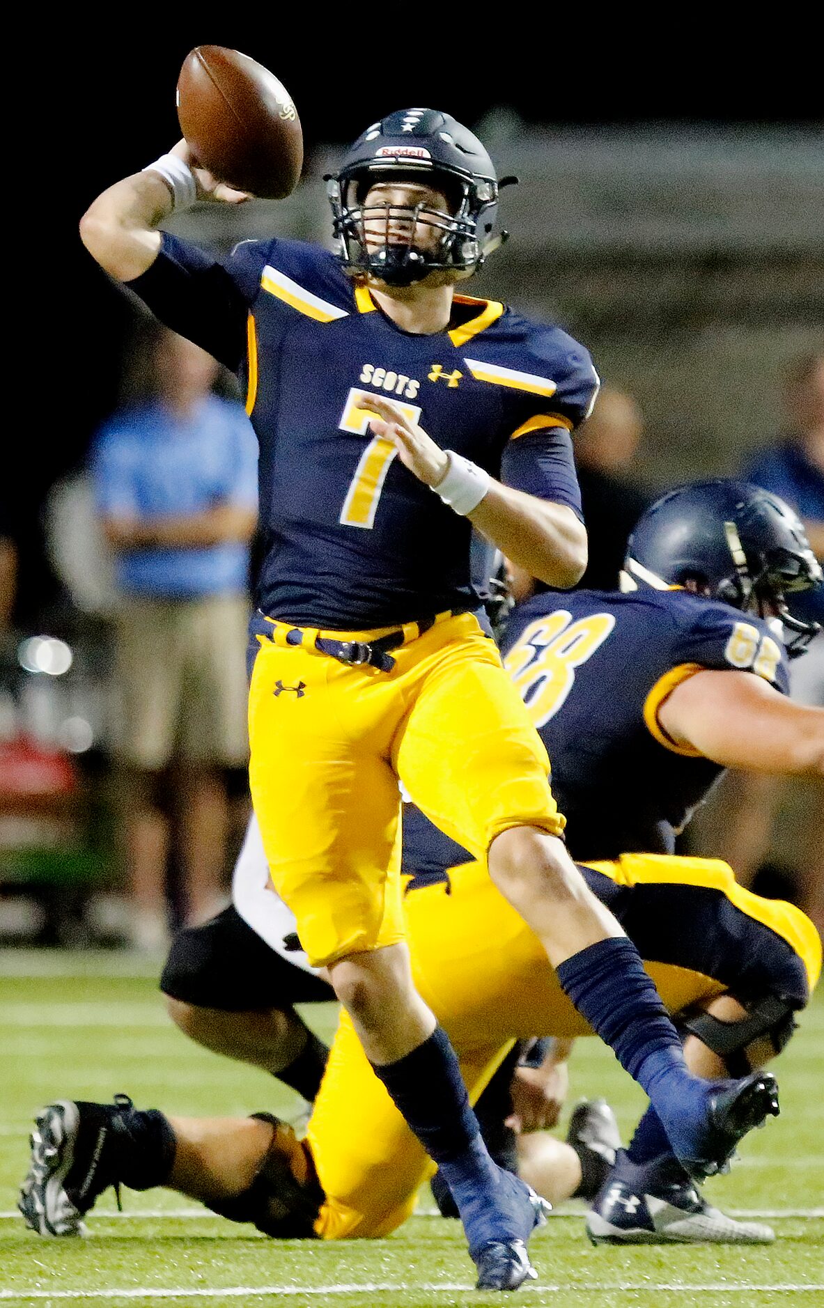 Highland Park High School quarterback Brennan Storer (7) throws a pass during the first half...