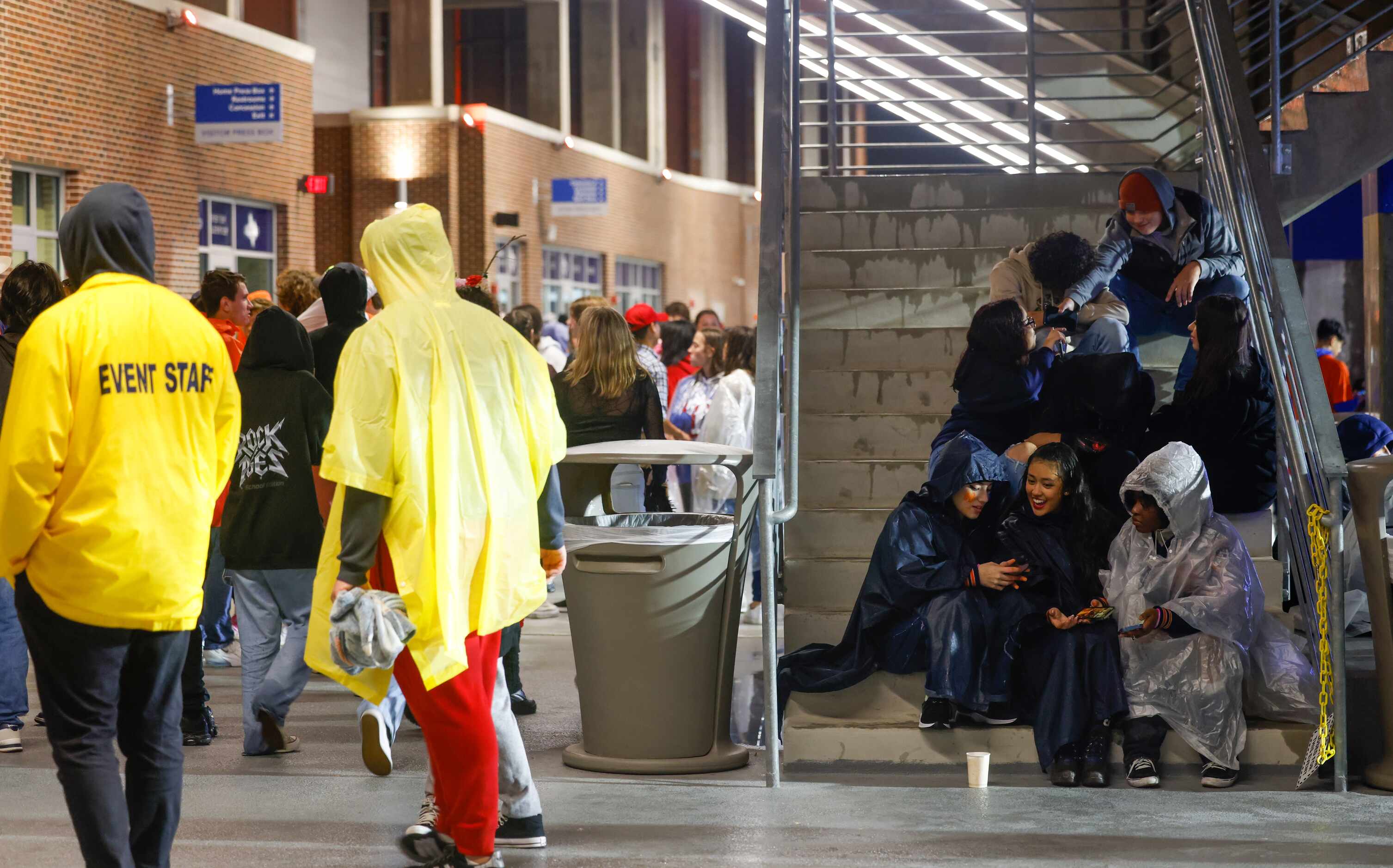 Bulldogs fans wait out weather delays for McKinney North’s game against Forney from the...