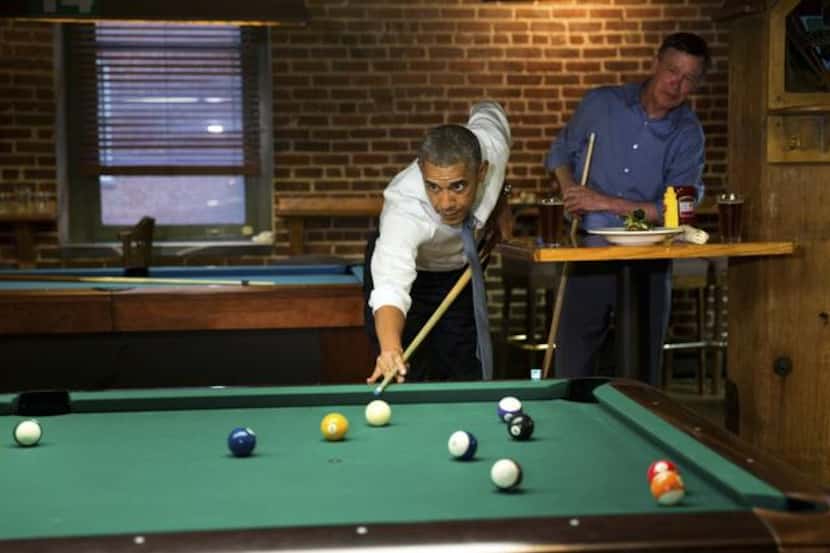 
President Barack Obama shoots pool with Colorado Gov. John Hickenlooper in Denver on Tuesday.
