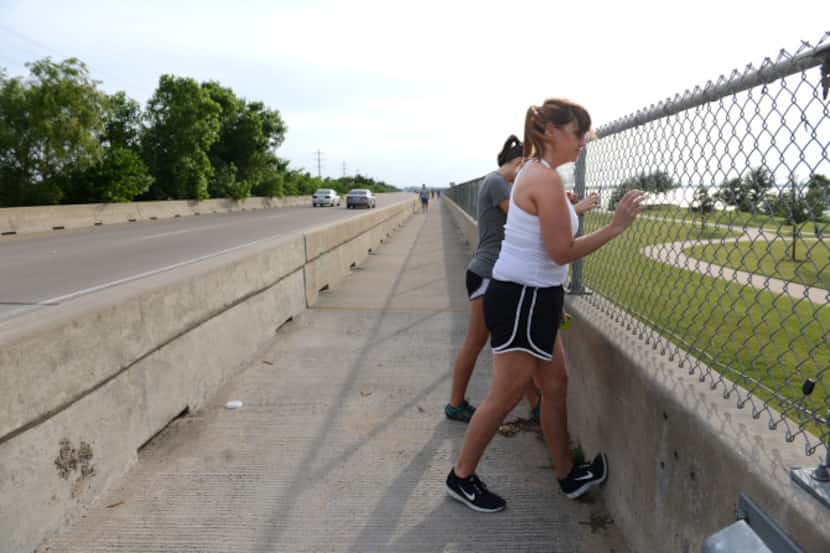 Tami Winkelmann (front) and Sydney Dearick stretch before crossing the State Highway 66...