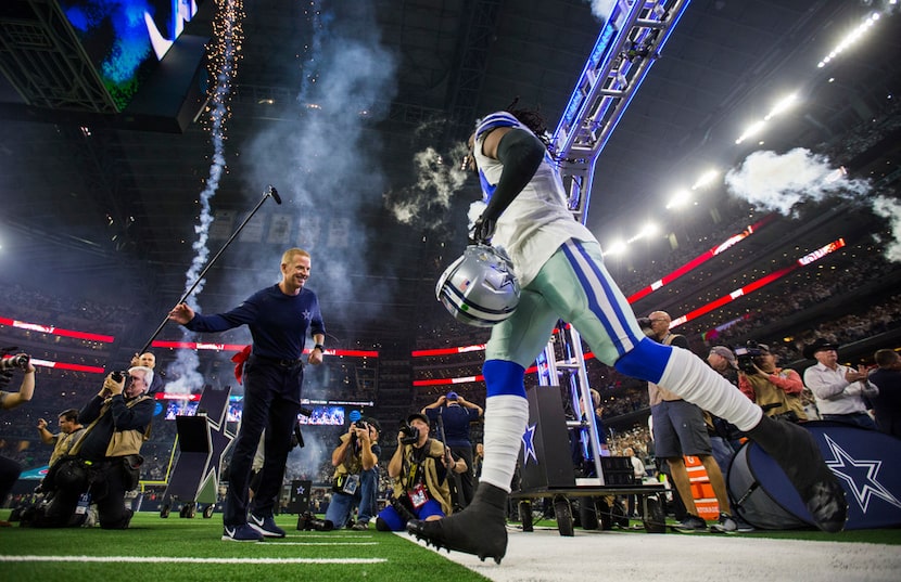 Dallas Cowboys middle linebacker Jaylon Smith (54) enters the field with head coach Jason...