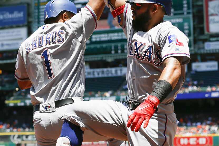 HOUSTON, TX - MAY 04:  Rougned Odor #12 of the Texas Rangers receives a high five from Elvis...