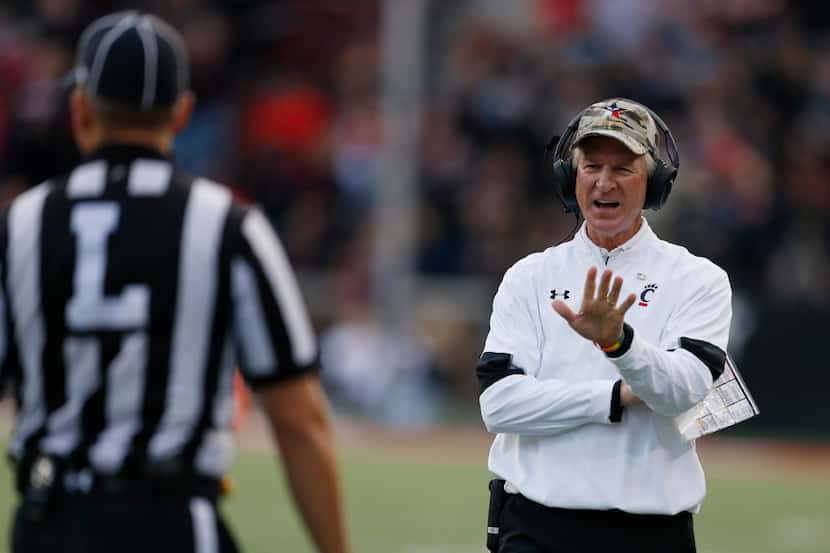 Cincinnati head coach Tommy Tuberville talks with a line judge during the second half of an...