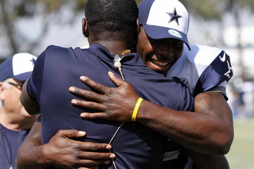 Dallas Cowboys wide receiver Dez Bryant (88) hugs former Dallas Cowboys player Michael Irvin...