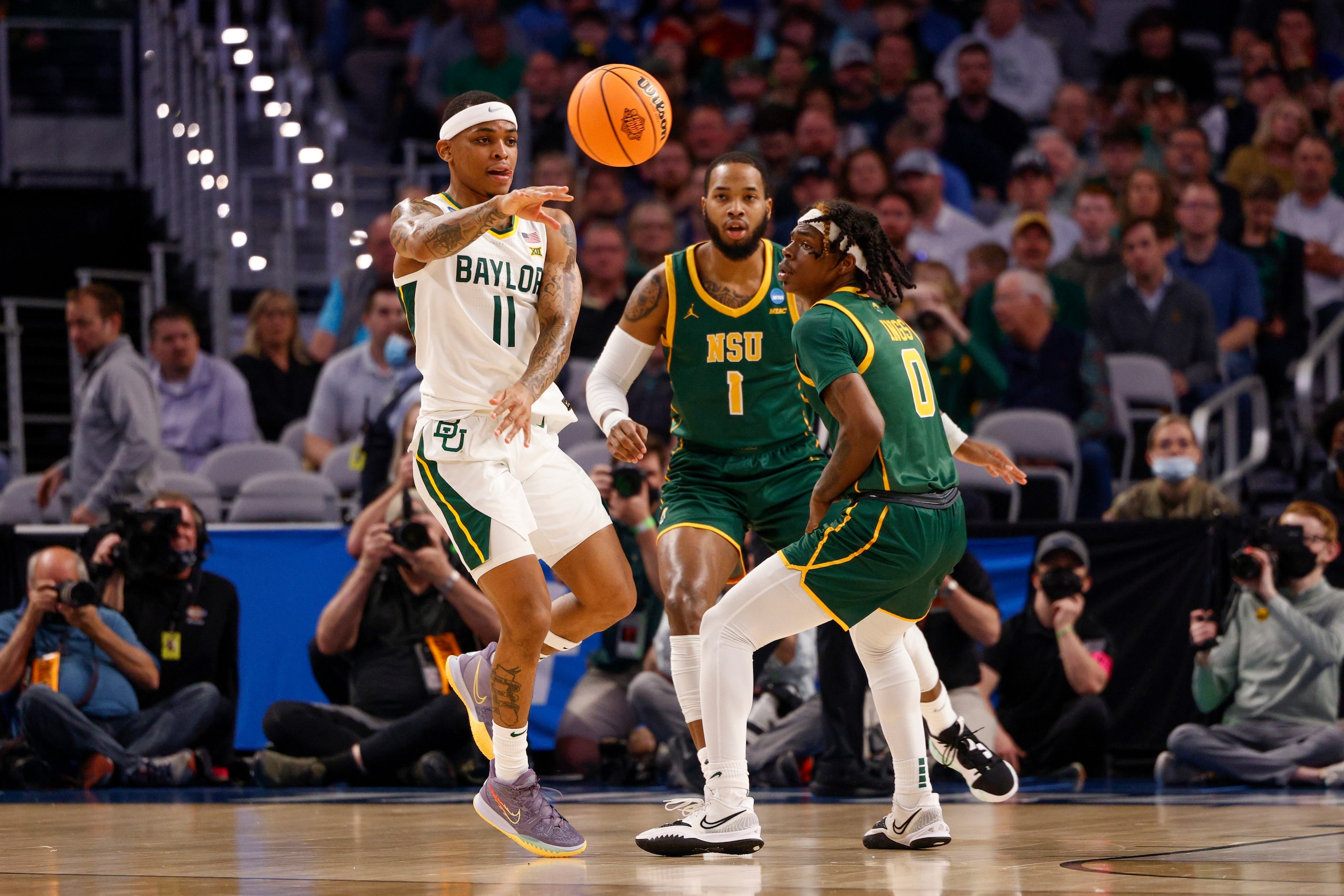 Baylor Bears guard James Akinjo (11) passes the ball around Norfolk State Spartans guard...