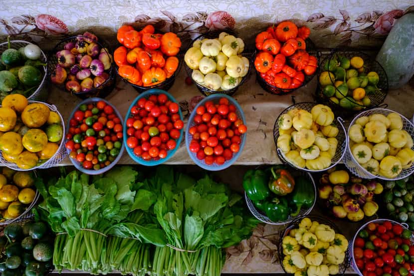 Hundreds of vendors pack the Hmongtown Marketplace, where fresh farmed vegetables are among...