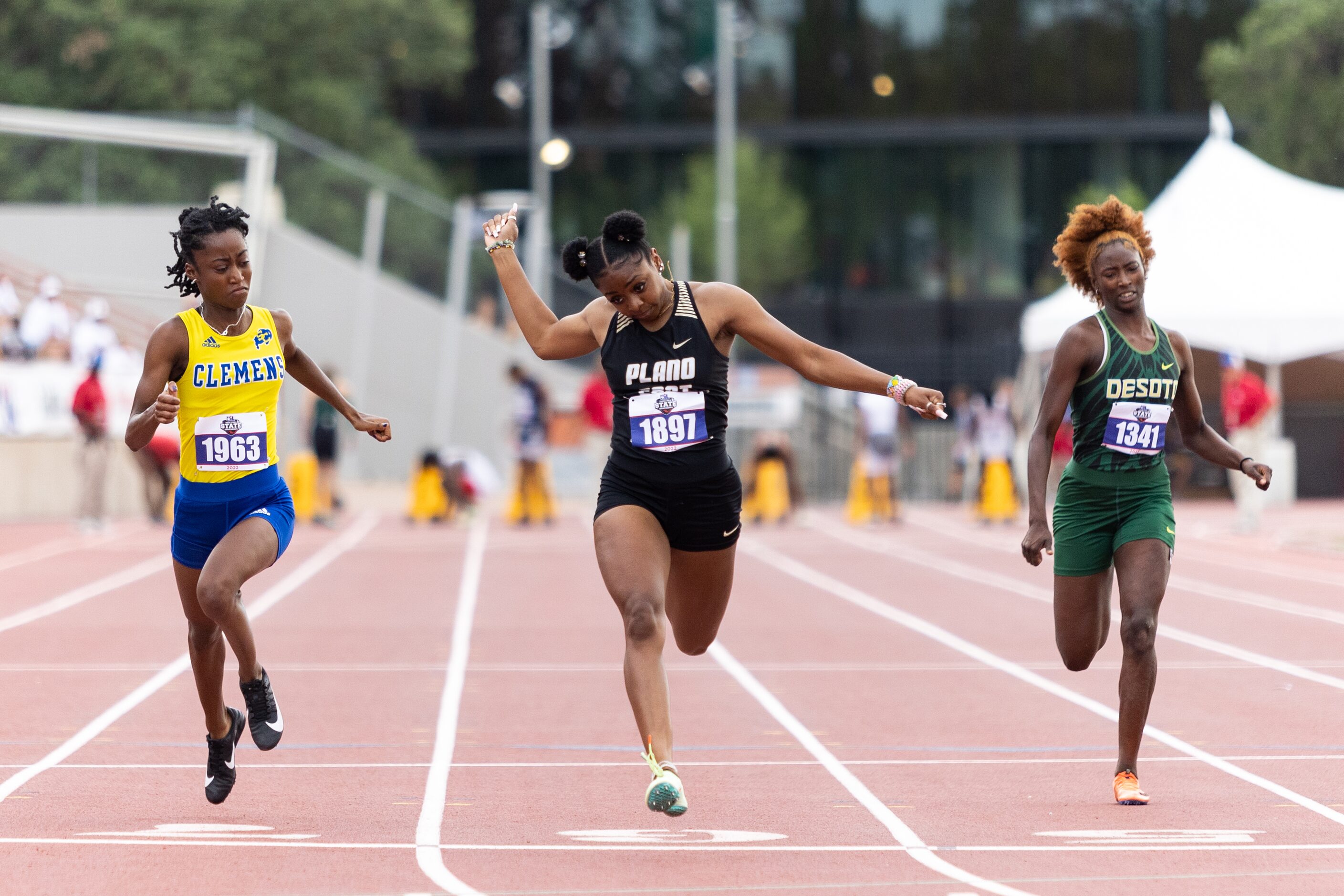 Tiriah Kelley of Plano East, center, races to the finish in the girls' 100-meter dash at the...