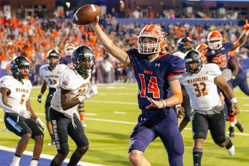 McKinney North quarterback Colin Hitchcock (14) celebrates after running in for a touchdown...