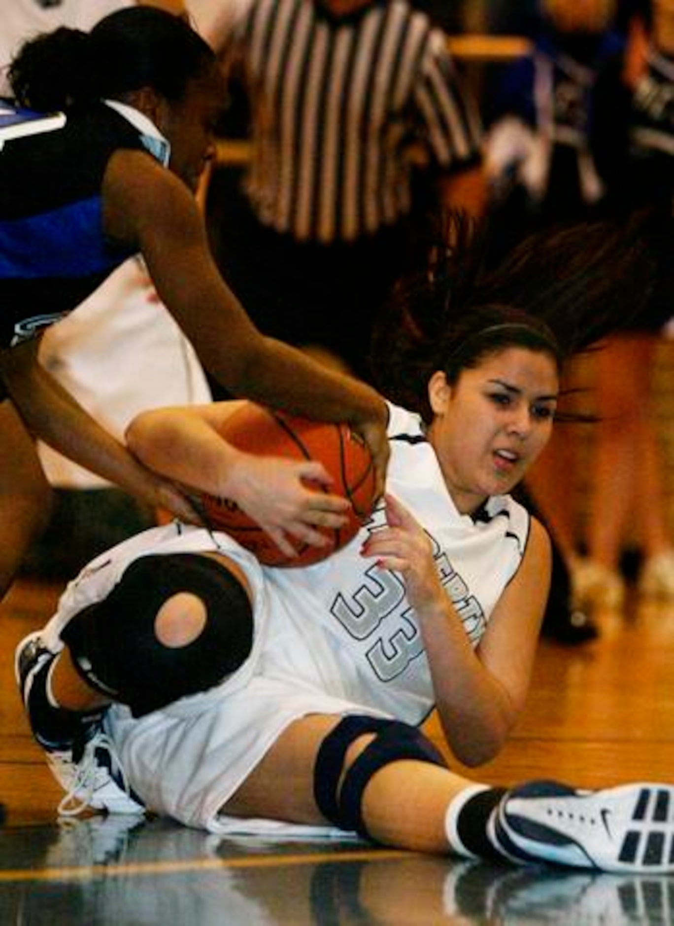 Argyle Liberty Christian sophomore forward Caitlin Flores (33) grabs a loose ball during the...