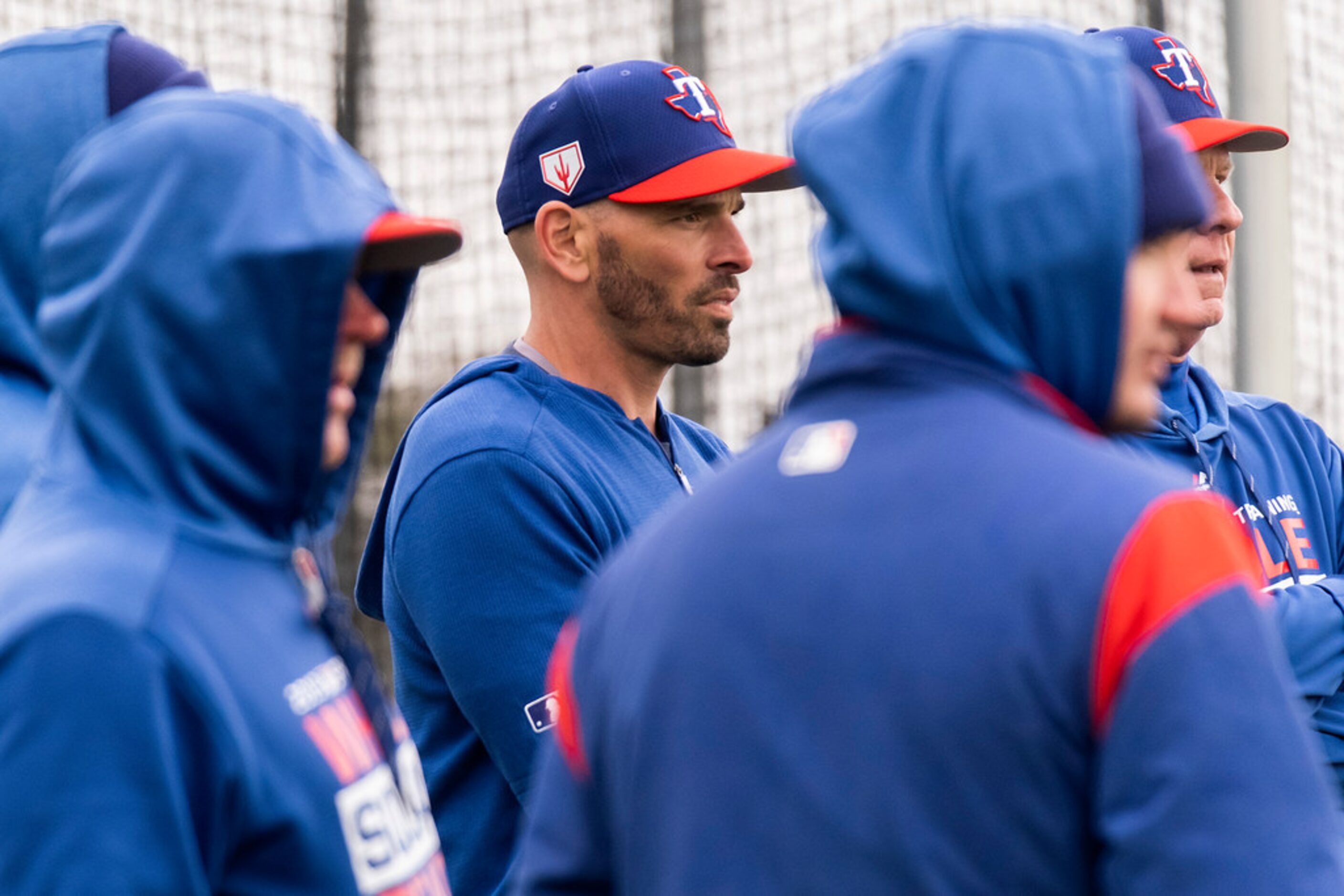 Texas Rangers manager Chris Woodward watches his position player go through a light spring...