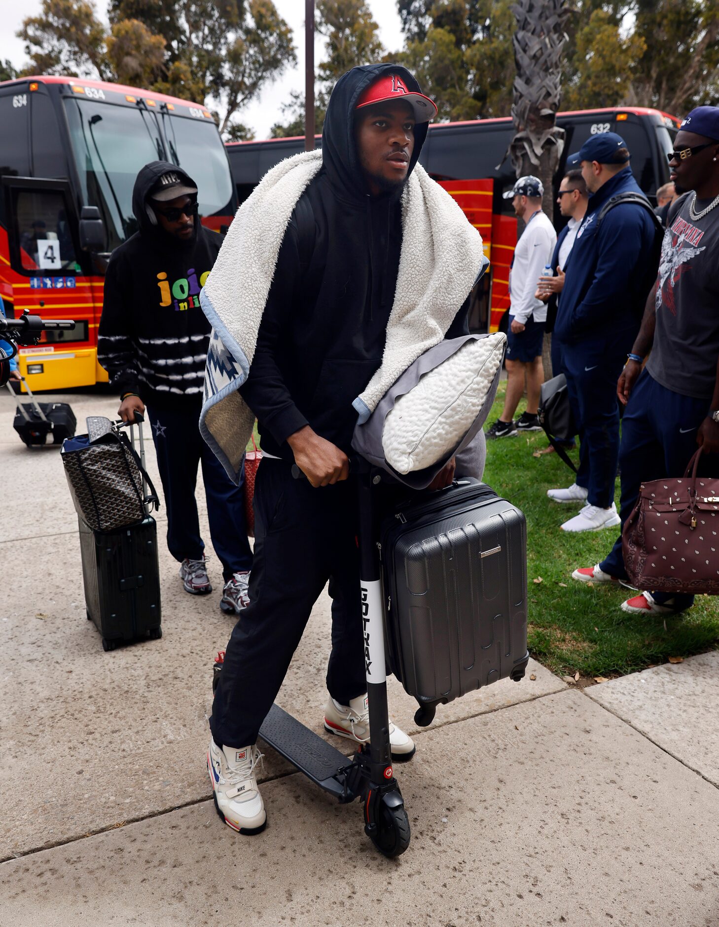 Dallas Cowboys linebacker Micah Parsons arrives on a scooter as he and his teammates arrive...