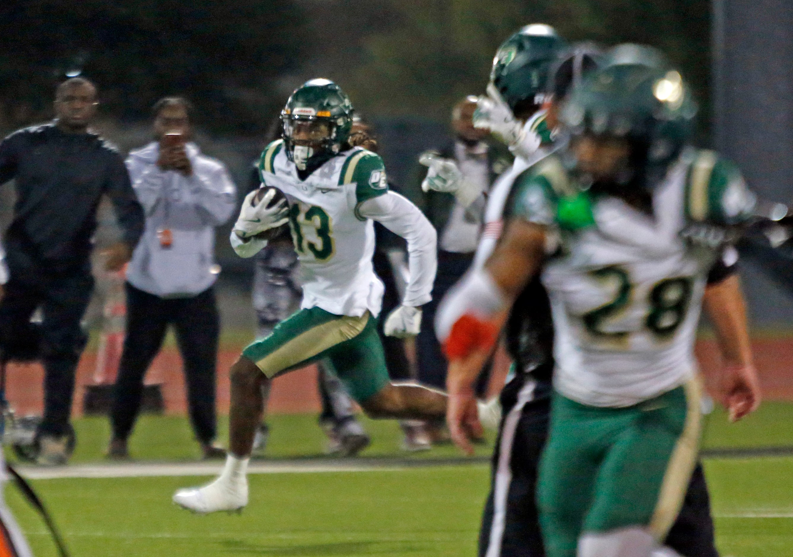 DeSoto High’s Daylon Singleton (13) makes a long run for a first down during the first half...