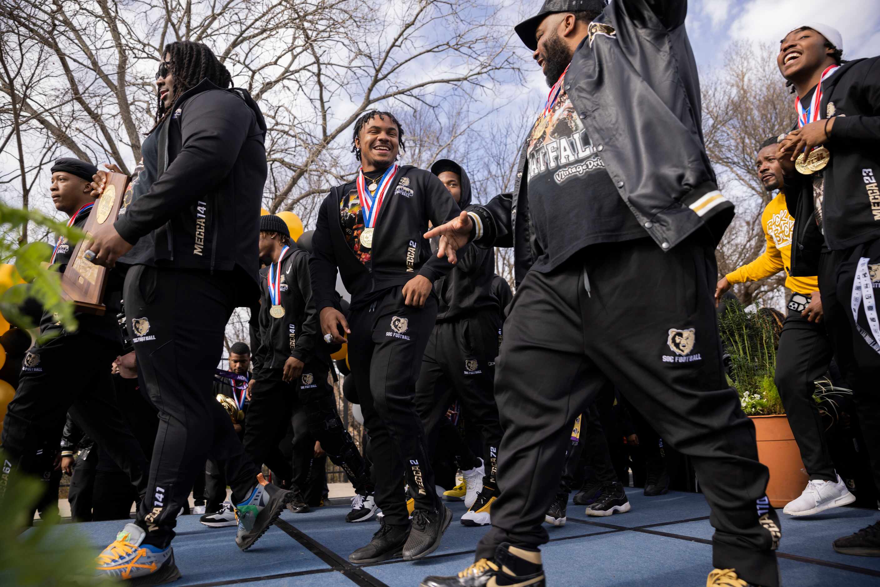 The South Oak Cliff Golden Bears walk on stage during a celebration for their Class 5A...