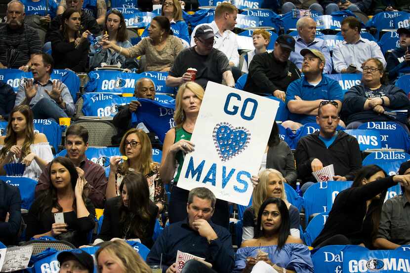 Dallas Mavericks fans cheer as their team warms up during the first half of the season...