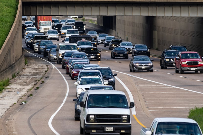 People make their way through morning rush hour on eastbound Interstate 30 in Dallas on...