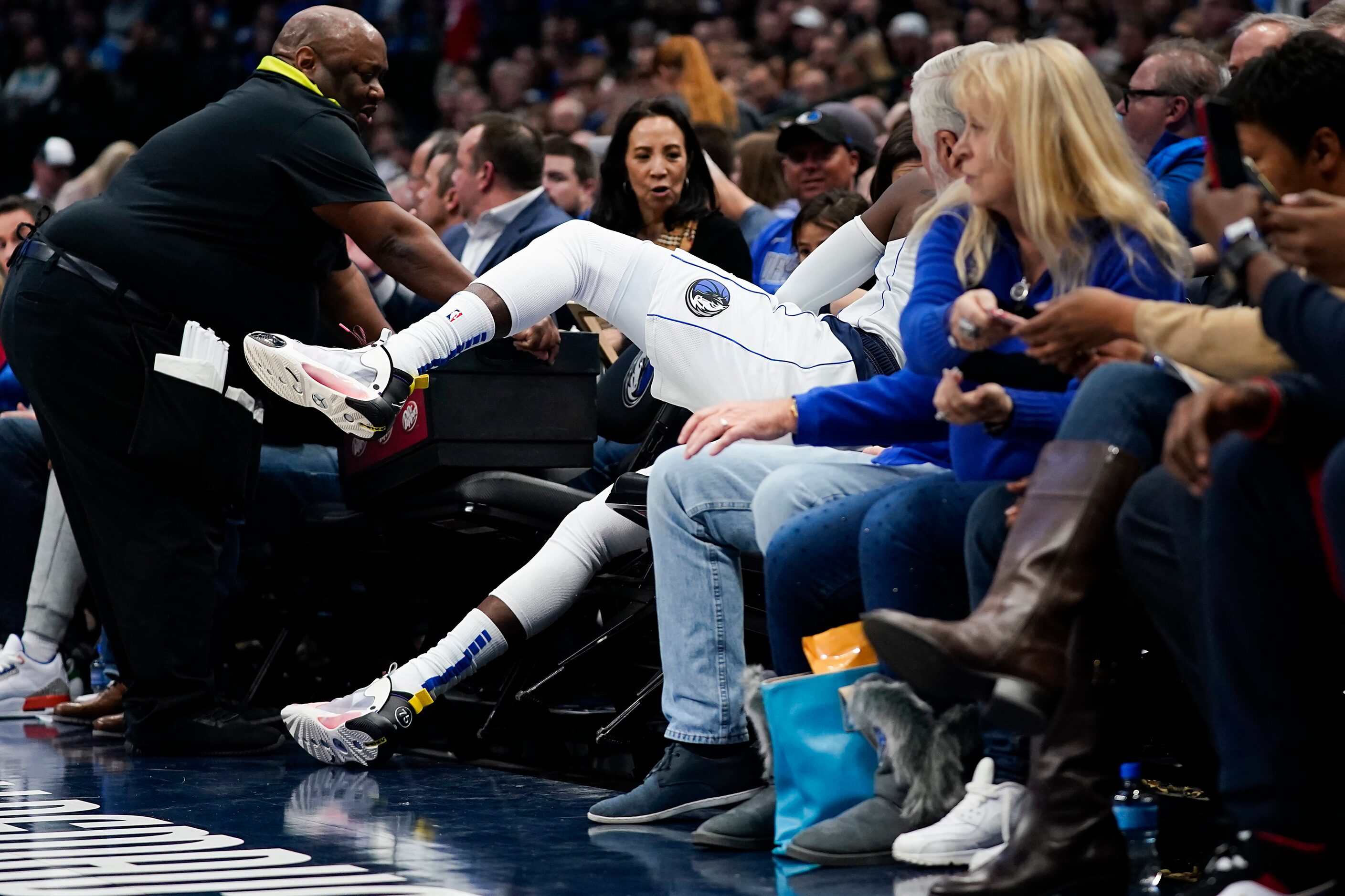 Dallas Mavericks guard Tim Hardaway Jr. (11) flies out of bounds to save a ball during the...