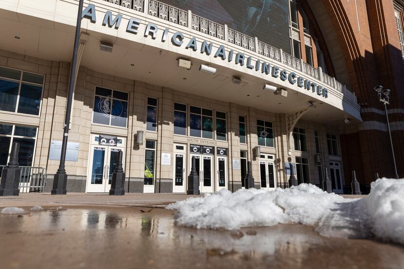 Snow melts in front of the American Airlines Center in Dallas on Saturday.