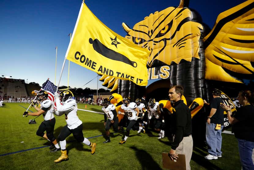 The Garland Owls take the field before the start of a high school football game against...