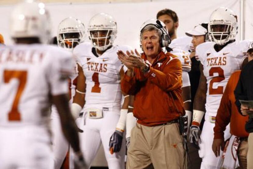 Texas coach Mack Brown applauds the performance team, ranked third in the nation.