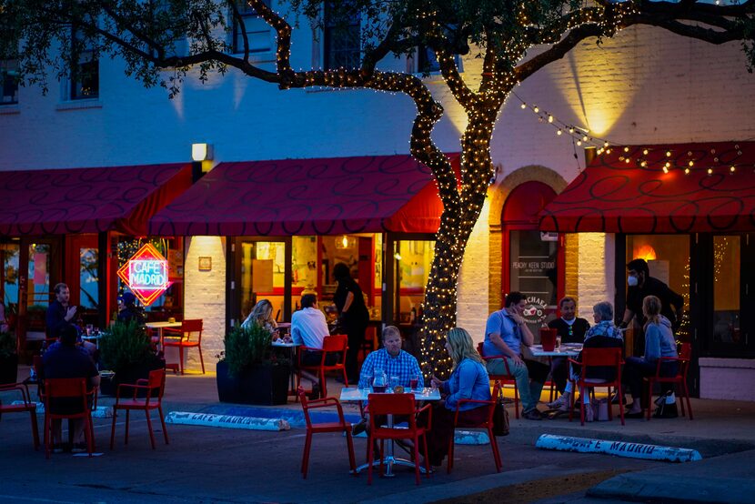 Patrons had dinner on tables spread out into the parking spaces in front of Cafe Madrid on...