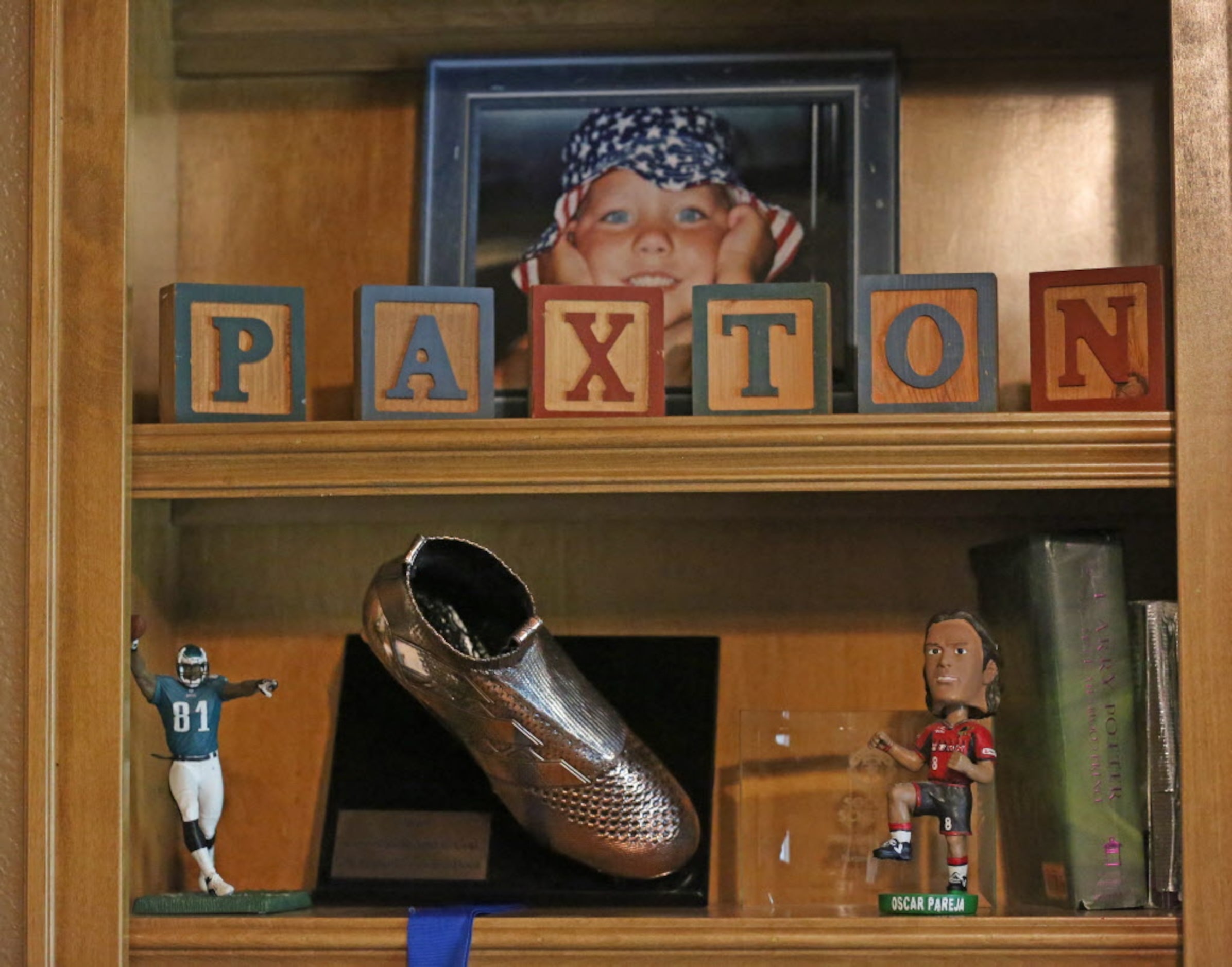 Some of the memorabilia of Paxton Pomykal, including a bobblehead of his FC Dallas coach. is...