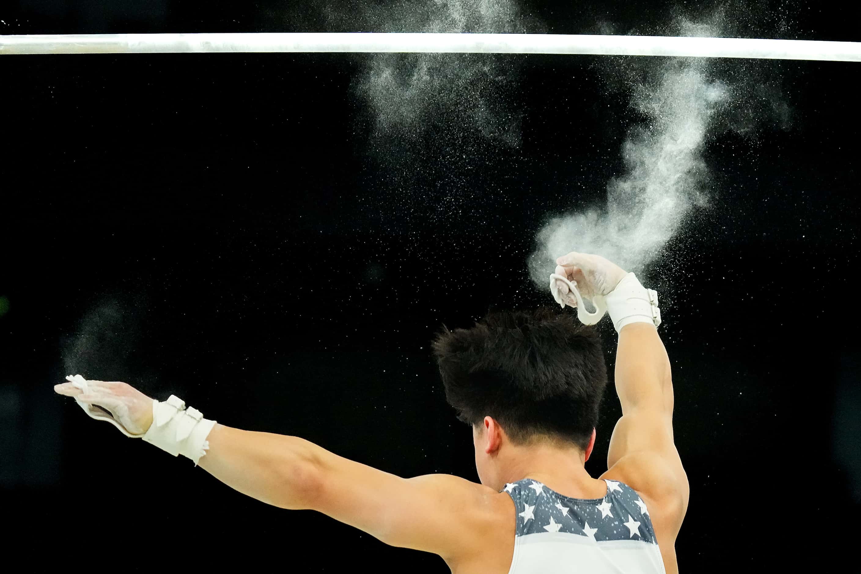 Asher Hong of the United States slips off the high bar during gymnastics podium training...