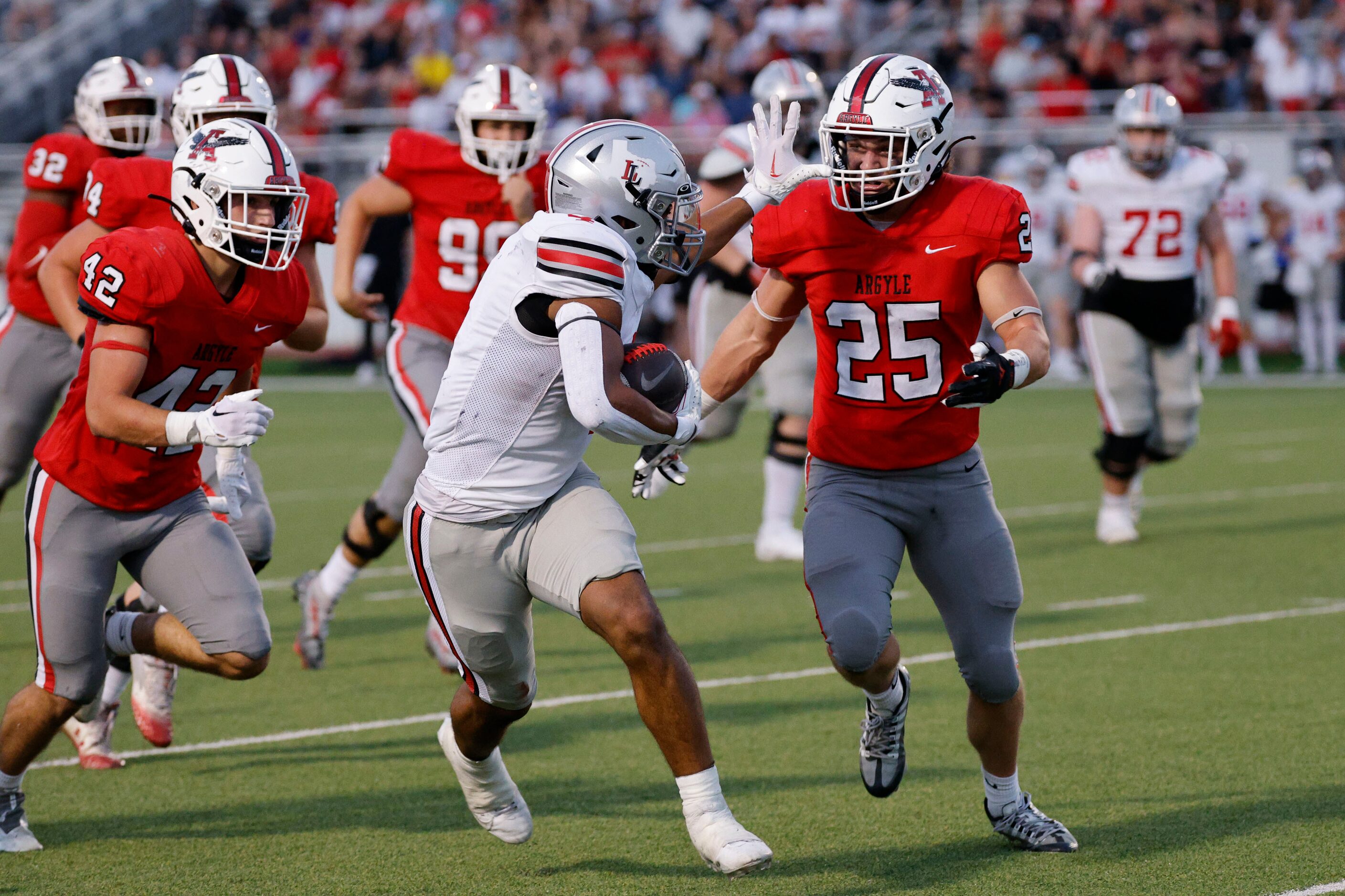 Lovejoy's Dante Dean (4) carries a ball as Argyle's Bud Petter (25) goes to stop him during...