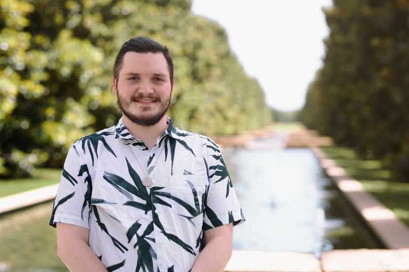 Equity Ambassador Clayton Gabel wears a black and white shirt and stands in front of a pond.