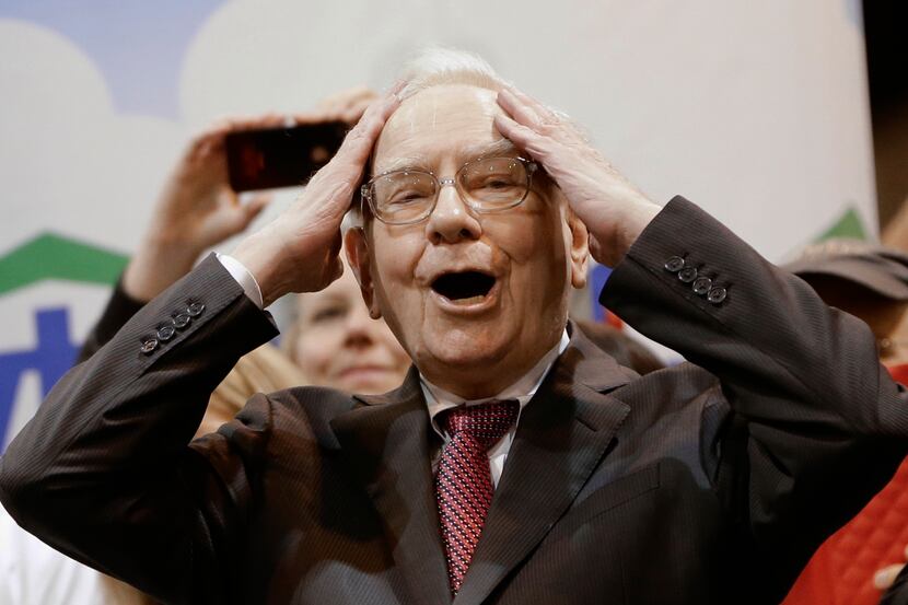 Berkshire Hathaway Chairman and CEO Warren Buffett reacted to a throw during the newspaper...