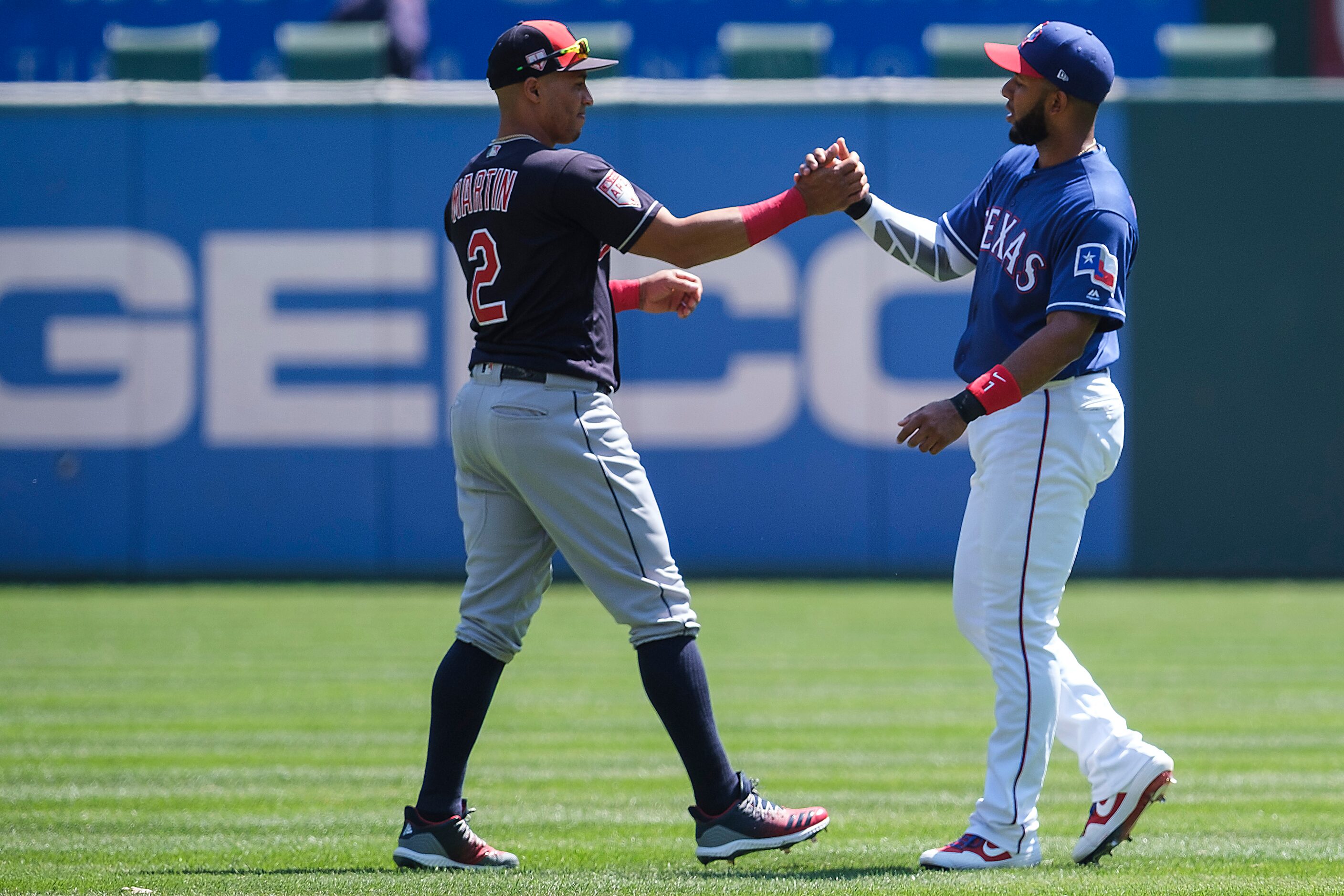 Texas Rangers shortstop Elvis Andrus (1) shakes hands with Cleveland Indians center fielder...