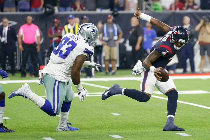 Houston Texans quarterback Deshaun Watson (4) evades Dallas Cowboys defensive tackle Daniel...