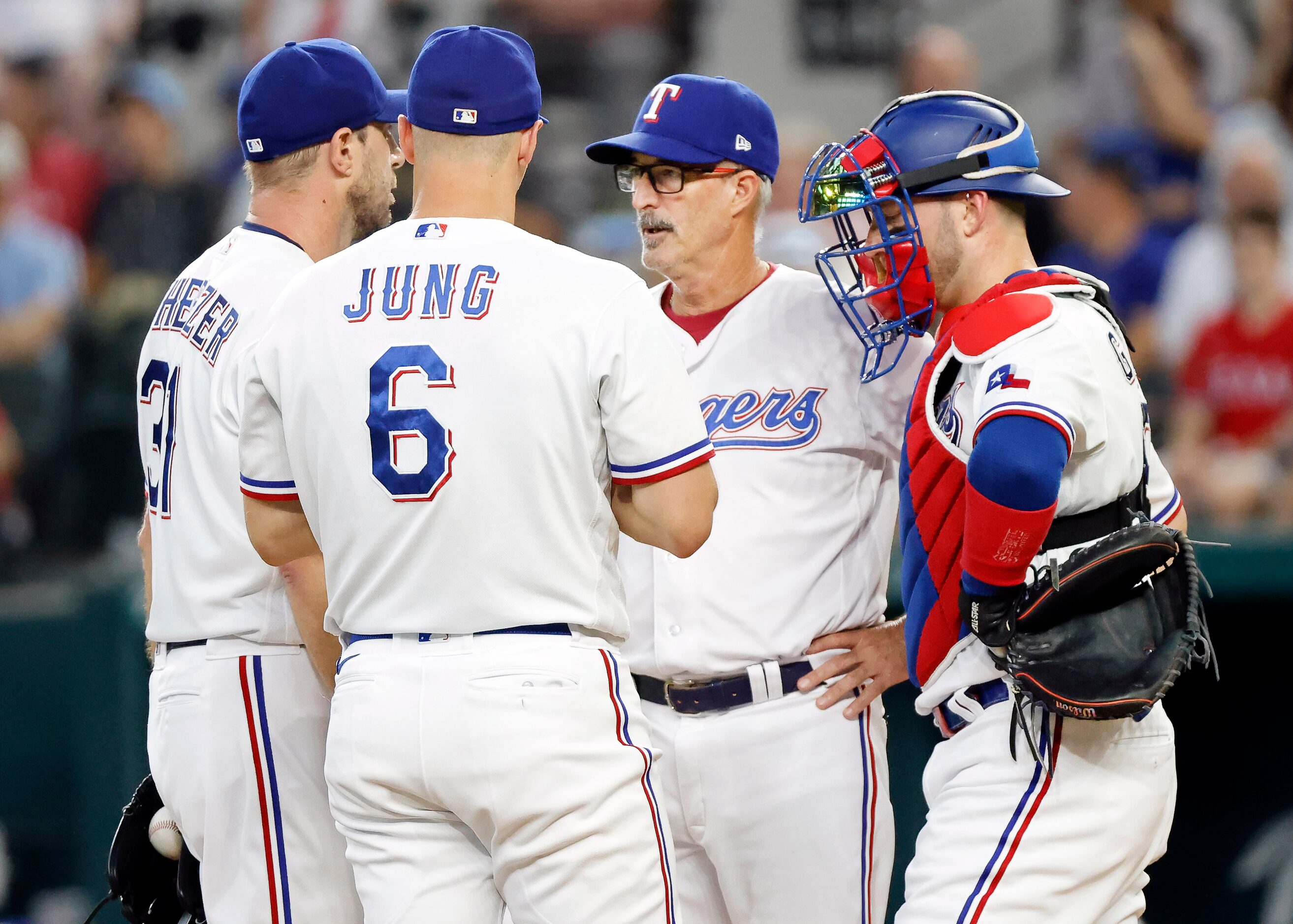 Texas Rangers starting pitcher Max Scherzer (31) recieves a visit to the mound by pitching...