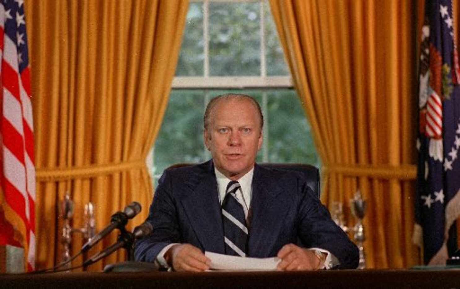  In a file photo President Gerald Ford reads a proclamation in the White House on Sept. 9,...