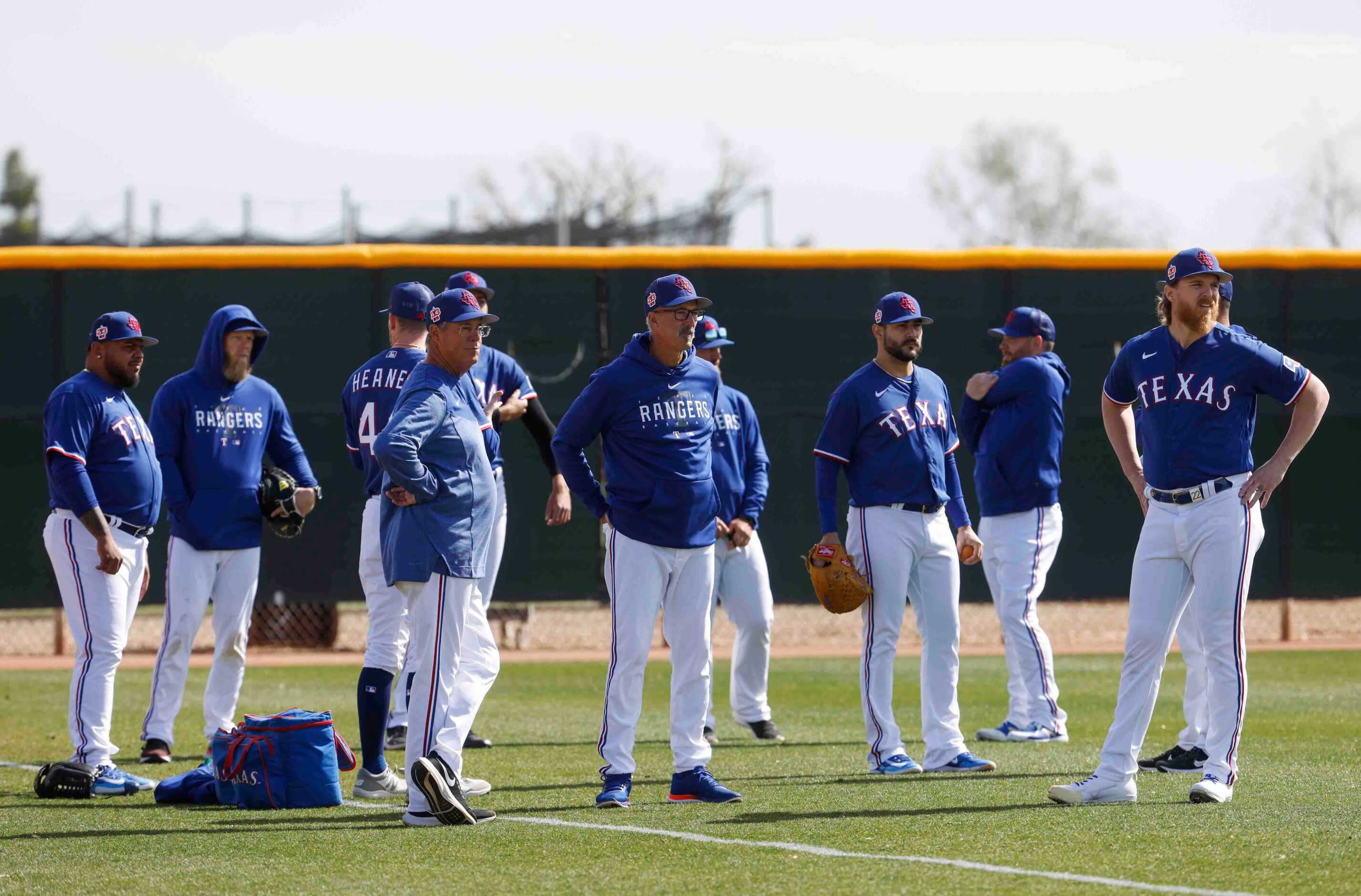 Texas Rangers special assistant Greg Maddux, center left, and pitching coach Mike Maddux,...
