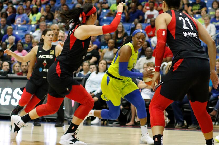 Dallas Wings guard Arike Ogunbowale (24) draws plenty of attention as she works around the...