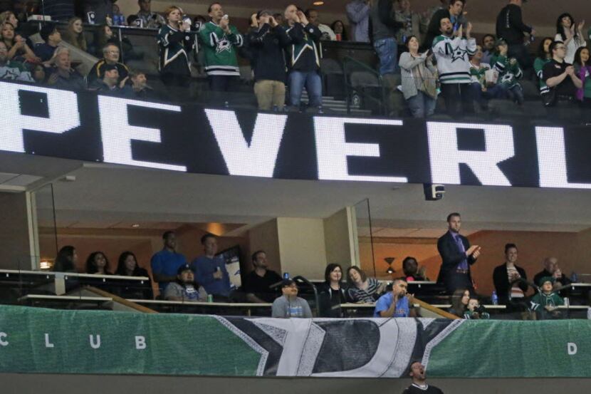 Dallas Stars fans applaud Rich Peverley during a first-period time out during action against...