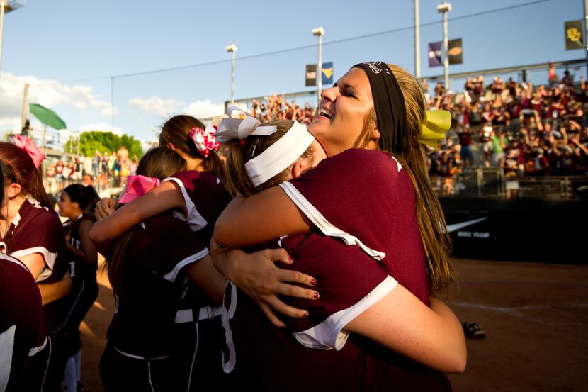Lewisville's Chloe Campise and Jessica Stahl celebrate winning the Class 5A softball state...