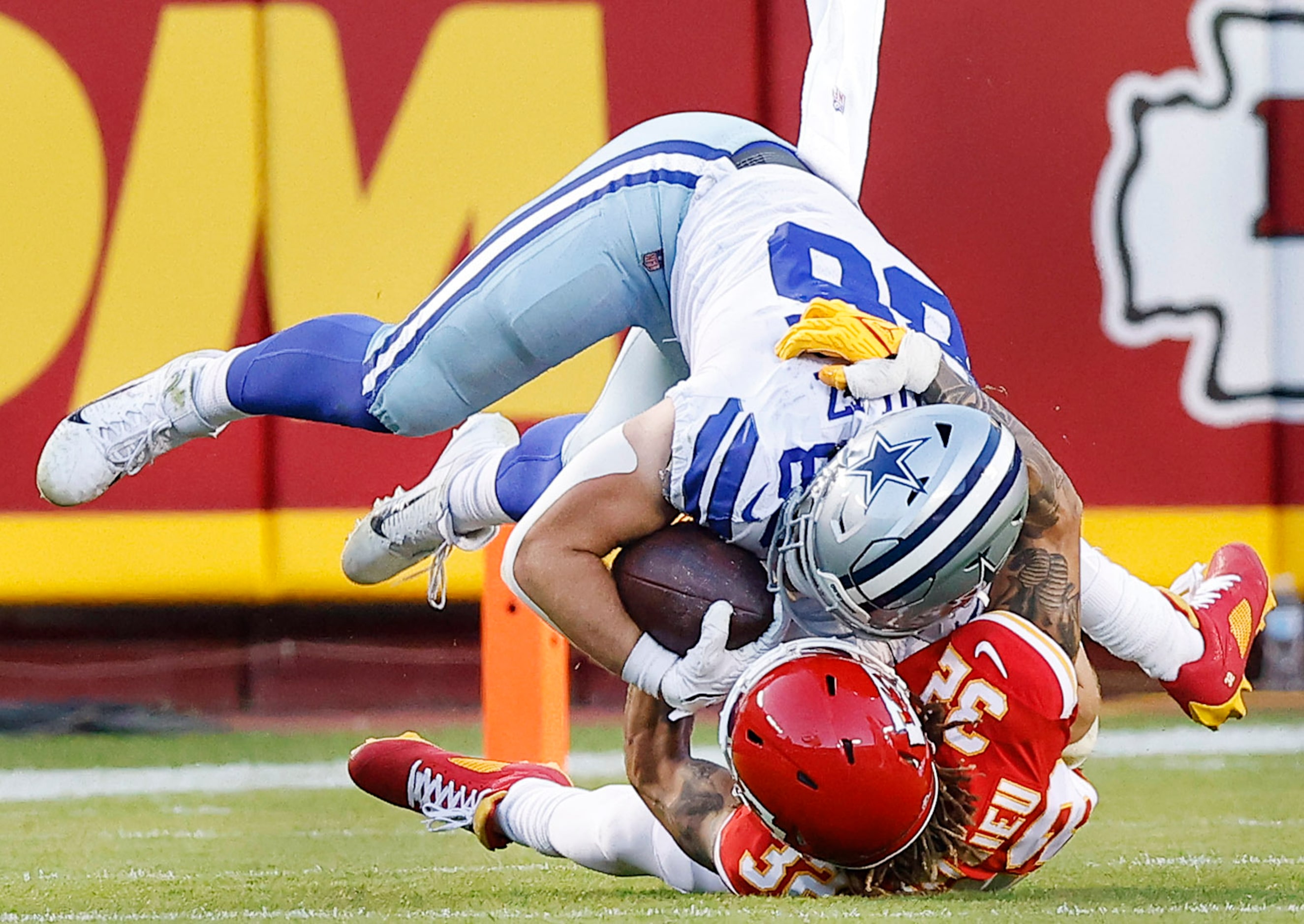 Kansas City Chiefs free safety Tyrann Mathieu (32) brings down Dallas Cowboys tight end...