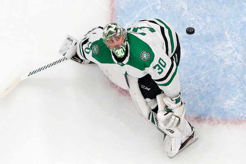 Dallas Stars goaltender Ben Bishop (30) eyes the puck which took flight above the crease and...